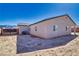 Back of the house with a bare lot, with a view of the mountains in the distance at 1580 S Outlaw St, Pahrump, NV 89060