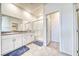 Bathroom featuring double vanity, granite countertops, and a glass door shower at 1580 S Outlaw St, Pahrump, NV 89060