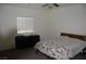 Bright bedroom with leafy patterned bedspread, dresser and window with closed blinds at 1580 S Outlaw St, Pahrump, NV 89060