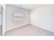 Bright and spacious bedroom featuring neutral carpet, a large window, and white walls at 1580 S Outlaw St, Pahrump, NV 89060