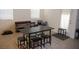 Dining room features tile flooring, a black table with seating for six, and neutral colored walls at 1580 S Outlaw St, Pahrump, NV 89060