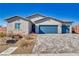 Single story new construction desert home, featuring a 3 car garage and desert landscaping at 1580 S Outlaw St, Pahrump, NV 89060