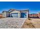 View of new construction home featuring desert landscaping, a gray exterior, and 3-car garage at 1580 S Outlaw St, Pahrump, NV 89060