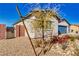 Front corner view of desert home, featuring a 3 car garage and gated side yard at 1580 S Outlaw St, Pahrump, NV 89060