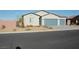 Charming single-story home with desert landscaping, a brick perimeter wall, and a two-car garage at 1580 S Outlaw St, Pahrump, NV 89060