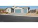 Charming single-story home with desert landscaping, a brick perimeter wall, and a two-car garage at 1580 S Outlaw St, Pahrump, NV 89060