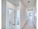 Hallway view with tile flooring leading to a doorway into a carpeted room at 1580 S Outlaw St, Pahrump, NV 89060