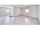 Living room featuring tile floors, ceiling fan, and ample natural light at 1580 S Outlaw St, Pahrump, NV 89060