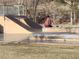 Person sitting on a skate park ramp with trees in the background at 18 Allegro St, Blue Diamond, NV 89004