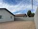 Backyard view featuring a block wall fence and a glimpse of neighboring houses at 1838 Princeton St, North Las Vegas, NV 89030