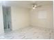 Bright bedroom featuring modern ceiling fan, light-filled window and stunning marble flooring at 1838 Princeton St, North Las Vegas, NV 89030