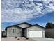 Charming single-story home with a gray exterior, two-car garage and low maintenance desert landscaping at 1838 Princeton St, North Las Vegas, NV 89030