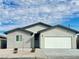 Charming single-story home featuring a neutral exterior, a two-car garage, and desert landscaping at 1838 Princeton St, North Las Vegas, NV 89030