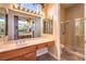 Bathroom with double sinks, makeup vanity, and glass enclosed shower at 1964 Oliver Springs St, Henderson, NV 89052