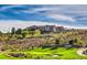 Stunning view of the Sun City Anthem clubhouse with manicured lawns and mature landscaping at 1964 Oliver Springs St, Henderson, NV 89052