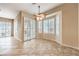 Bright, neutral room with tile floors, large windows with shutters and unique palm-style ceiling fan at 1964 Oliver Springs St, Henderson, NV 89052