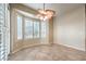 Bright, neutral room with tile floors, large bay windows and ceiling fan with unique palm-style blades at 1964 Oliver Springs St, Henderson, NV 89052