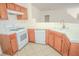 Kitchen with tile flooring, white appliances, and wood cabinets at 2050 N Los Feliz St # 176, Las Vegas, NV 89156