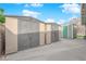 Backyard with multiple storage sheds and a concrete patio with clear blue skies at 2058 Citroen St, Las Vegas, NV 89142