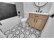 Bathroom with modern fixtures, stylish tile flooring, soaking tub, and natural wood vanity at 2058 Citroen St, Las Vegas, NV 89142