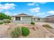 Charming single-story home featuring desert landscaping and a stone walkway to the front entrance at 2058 Citroen St, Las Vegas, NV 89142