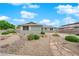 Charming single-story home featuring desert landscaping and a stone walkway to the front entrance at 2058 Citroen St, Las Vegas, NV 89142