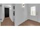 Bright hallway with wood-look floors, leading to the front door and bathroom at 2058 Citroen St, Las Vegas, NV 89142