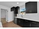 The modern kitchen is complete with stainless steel appliances, a sink, and sleek black cabinets at 2058 Citroen St, Las Vegas, NV 89142