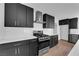 Close-up of a kitchen with dark cabinets, stainless appliances, and sleek hardware at 2058 Citroen St, Las Vegas, NV 89142