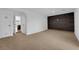 Spacious living room with neutral carpet, accent wall, and entrance into the next room at 2058 Citroen St, Las Vegas, NV 89142