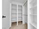 Bright walk-in closet with custom white shelving for optimal organization and storage at 2058 Citroen St, Las Vegas, NV 89142