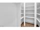 Walk-in closet featuring custom shelves for storing clothes and personal items at 2058 Citroen St, Las Vegas, NV 89142