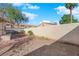 A cozy backyard featuring gravel landscaping, mature trees, and privacy walls for outdoor enjoyment at 2136 Velvet Hill Ave, Las Vegas, NV 89106