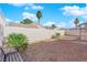 A spacious backyard featuring gravel landscaping, desert plants, bench, and privacy walls at 2136 Velvet Hill Ave, Las Vegas, NV 89106