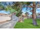 Cozy home featuring attached garage, fresh green lawn, mature trees, and a welcoming front entrance at 2136 Velvet Hill Ave, Las Vegas, NV 89106