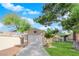 A one-car garage with a concrete driveway sits in front of a well-maintained lawn and mature trees at 2136 Velvet Hill Ave, Las Vegas, NV 89106