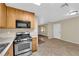 Kitchen with stainless steel appliances, tile flooring, and access to additional room at 2136 Velvet Hill Ave, Las Vegas, NV 89106