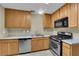 Traditional kitchen featuring wood cabinets, stainless steel appliances, and light countertops at 2136 Velvet Hill Ave, Las Vegas, NV 89106