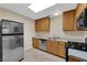 Cozy kitchen featuring stainless steel appliances, tile flooring, and wood cabinets at 2136 Velvet Hill Ave, Las Vegas, NV 89106