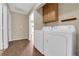 Functional laundry room featuring washer, dryer, and overhead cabinets at 2136 Velvet Hill Ave, Las Vegas, NV 89106