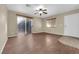 Well-lit living room boasting wood-look floors, sliding glass doors, ceiling fan and a side entrance at 2136 Velvet Hill Ave, Las Vegas, NV 89106