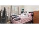 Bedroom featuring a floral pink coverlet bed, chest of drawers, and bright natural light at 2510 Influential Ct, North Las Vegas, NV 89031