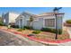 Neutral colored one-story home with desert landscaping, and covered front entry at 2510 Influential Ct, North Las Vegas, NV 89031