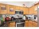 Well-equipped kitchen with wooden cabinets, stainless steel appliances, and a gas range at 2510 Influential Ct, North Las Vegas, NV 89031