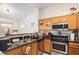 Functional kitchen offering wooden cabinets, stainless steel appliances, and black countertops at 2510 Influential Ct, North Las Vegas, NV 89031