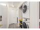 Bright laundry room featuring a stackable washer and dryer with neutral flooring at 2510 Influential Ct, North Las Vegas, NV 89031