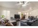 Bright living room offering tile floors, a comfortable sectional sofa, and access to the dining area at 2510 Influential Ct, North Las Vegas, NV 89031