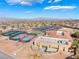 An aerial shot of community amenities showcasing tennis courts, a pool, and a recreation center against scenic hills at 2633 Flare Star Dr, Henderson, NV 89044