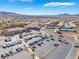 Panoramic aerial shot of a community center featuring plentiful parking, tennis courts, and desert landscaping at 2633 Flare Star Dr, Henderson, NV 89044