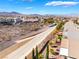 Expansive community aerial view shows the drainage canal, desert landscape, and beautiful mountain views at 2633 Flare Star Dr, Henderson, NV 89044